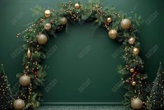 a christmas wreath with balls and ornaments on green wall in an empty room decorated for the holiday season