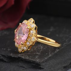 Vintage-inspired oval pink sapphire engagement ring features a unique cluster design with gold accents, perfect for a promise ring. Drawing from the art deco era, the ring showcases a nature-inspired leaf and branch motif, enhanced by the elegant pink sapphire gemstone, making it an ideal choice for a September birthstone. Ring Details Material: 14k Solid Gold Gold Color Options: White Gold, Yellow Gold, Rose Gold Center Stone: Lab pink sapphire Stone Shape: Oval cut 6x8mm -1.50CT Side Stones: M Whimsical Engagement Ring, Pink Engagement Ring, Pink Sapphire Ring Engagement, Gold Promise Rings, September Birthstone, Sapphire Stone, Sapphire Gemstone, Pink Sapphire, Promise Rings