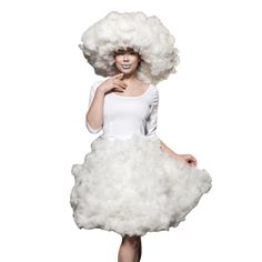 a woman in a white dress and big fluffy hair