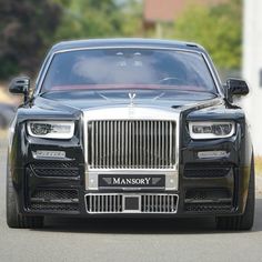 the front end of a black rolls royce