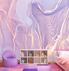 a room with a purple and pink wallpaper, bookshelf and bed in it