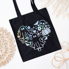 a black tote bag sitting on top of a table next to a doily