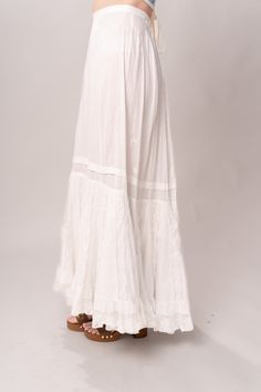 Stunning Edwardian 1910’s white cotton and lace maxi petticoat skirt. With a pretty flare silhouette, panel lace detail, and a button closure at waist. Good vintage condition, with normal wear and condition for its age. Some areas of visible mending a minor staining - see pictures. Best fits modern size XS/S Waist 26”Length 42” Featured top is the Blue Doll Quilt Corset from our friends at Psychic Outlaw. Model’s Measurements:Height 5’9”Chest 34”Waist 29”Hips 36.5” White Lace Patchwork Long Skirt, White Maxi Skirt For Daywear, Daywear Long Lace Skirt, Lace Maxi Skirt With Lace Trim, Flowy Maxi Skirt With Lace Trim, Summer Maxi Length Bottoms With Lace Trim, Summer Maxi Bottoms With Lace Trim, White Lace Vintage Bottoms, Vintage White Lace Bottoms