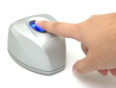 a finger pressing the button on an electronic device with various logos behind it and below