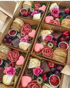 four boxes filled with different types of desserts and candies on top of each other