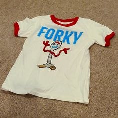 Toy Story 4 Forky Character T Shirt With Red Collar And Sleeve Cuffs. No Tags, But Shirt Was Never Worn. Fun Red T-shirt For Playtime, Red Character Print T-shirt For Playtime, Red Letter Print Top For Playtime, Red Letter Print Tops For Playtime, White Cotton Tops For Play, White Fun T-shirt For Playtime, Fun White T-shirt For Playtime, White Fun Style T-shirt For Playtime, Top Toddler Toys