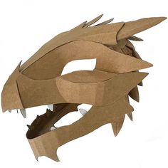 a paper dragon mask is shown on a white background and looks like it's made out of cardboard