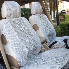 the interior of a car with two seats covered in knitted material