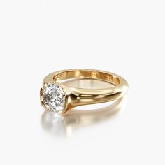 a yellow gold ring with a single diamond on the top and bottom, set against a white background