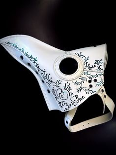 a white mask with black and blue designs on it