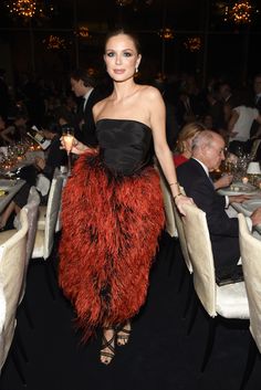 a woman in a black and red dress at a dinner