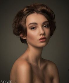 a woman with brown hair is posing for the camera