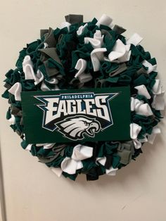 the philadelphia eagles wreath is hanging on the wall