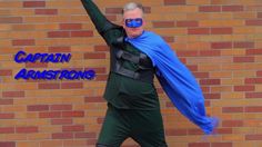 a man dressed in green and blue is holding his arms up with the words captain armstrong on it