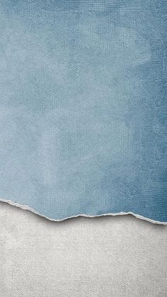 an image of a blue and white background with torn off paper on the bottom half