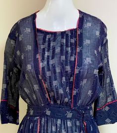 "A stunning OOAK handmade 1900s  - 1920s Edwardian antique ladies day dress in the prettiest geometric printed semi-sheer fabric in rich shades of navy blue & white with lovely burgundy piping.  One of the very prettiest I've ever seen!  Looks pretty enough for museum quality, imo, yet still very femme & flattering by modern aesthetics.  I love a white cotton muslin Edwardian dress -- I have one for sale in this shop! -- but richly colored ones like this treasure are equally beautiful and MUCH harder to find!  Lovely traditional bodice.  Two large femme, sweet rectangular sashes hang from the hips at each side, also piped in burgundy.  This dress closes with snaps and hooks -- you step into it and then close it up -- if you're unfamiliar with Edwardian period dresses, I included a pic of i Edwardian Wrapper, 1920s Day Dress, Period Dresses, Retro Clothes, Ladies Day Dresses, Period Dress, Edwardian Dress, Dress Handmade, Cotton Muslin