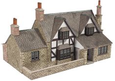 an image of a model house that is made out of wood and brick with two chimneys