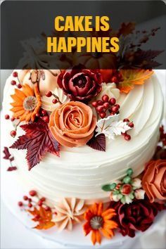 a white cake with flowers and leaves on it that says cake is happines