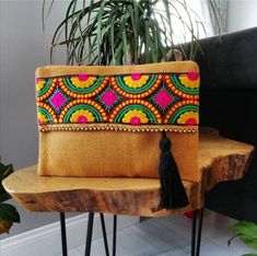 This bohemian handbag will bring elegance to your style. It will be chic with jeans or dresses and you may use this clutch bag both day and night.  This clutch bag is perfectly handmade with high quality mustard yellow jute fabric. Designed with a silk bohemian embroidery and a tassel. Clutch has a silk satin interfacing and a padding inside to stand upright. Closes with a magnet closing.  This bag is designed to fit all the things you need for comfortable everyday busy life. There will be enoug Bohemian Clutch, Bohemian Embroidery, Bohemian Handbags, Boho Clutch, Embroidered Handbag, Pouch Tutorial, Jute Fabric, Floral Clutches, Bohemian Bags