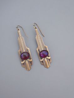 "Vintage Jewelry - Art Deco Earrings - Purple Earrings - Brass jewelry - Dragon's Breath Earrings - Chloe's Vintage Handmade Jewelry Awesome vintage brass Art Deco earrings embellished with gorgeous purple fuschia Dragon's breath glass stones. The brass has a soft warm patina. Chloe says, Wear them and feel fabulous!\" They measure 2 1/4\" long from the top of the ear wire. Thanks for visiting Chloe's" Artistic Purple Jewelry With Matching Earrings, Nickel-free Dangle Art Deco Earrings, Nickel-free Art Deco Dangle Earrings, Nickel-free Art Deco Metal Earrings, Nickel-free Dangle Earrings In Art Deco Style, Art Deco Style Matching Metal Earrings, Handmade Brass Art Deco Earrings, Art Deco Metal Drop Earrings, Art Deco Pierced Metal Jewelry