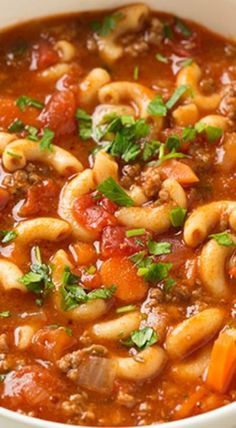 a white bowl filled with pasta and meat soup