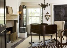 a living room filled with furniture and a piano