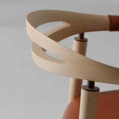 a close up of a wooden chair with curved legs