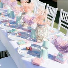 the table is set with pink and blue decorations