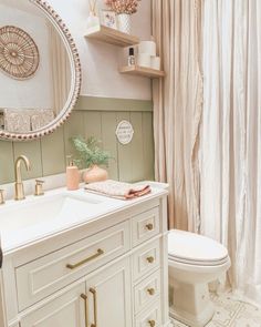 a bathroom with a toilet, sink and mirror in it's centerpieces