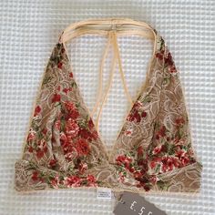 Beautiful Nude Colored Halter Bralette With Pretty Rose Detail Summer Beach Bra With Floral Print, Feminine Beige Bra For Spring, Beige Fitted Bra For Beach, Fitted Beige Bra For Beach, Fitted Floral Print Summer Bra, Summer Floral Print Fitted Bra, Feminine Beach Bra For Spring, Bra Friendly T-back Halter Top For Spring, Spring T-back Bra Friendly Halter Top