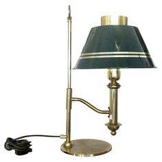 a table lamp with a blue shade on it and a black cord plugged into the base