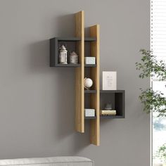 a wall mounted shelf next to a white couch in a living room with grey walls