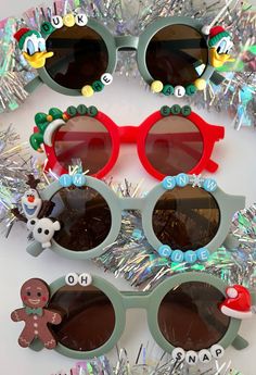 three pairs of sunglasses with christmas decorations on them and tinsel around the rims