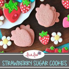 strawberry sugar cookies on a plate with flowers and strawberries in the background text overlay reads lula loa's strawberry sugar cookies