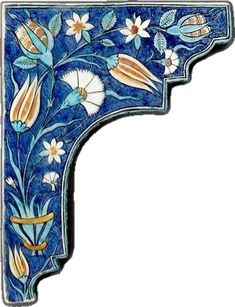 an ornate blue and white wall shelf with flowers on the top, inlayed to it's sides