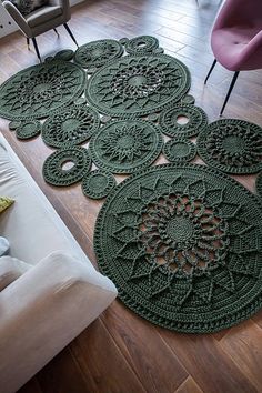 a living room area with green rugs on the floor