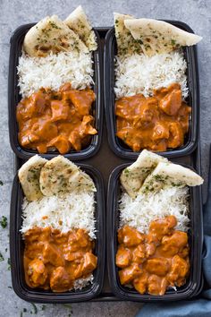 four black trays filled with rice and different types of food on top of each other