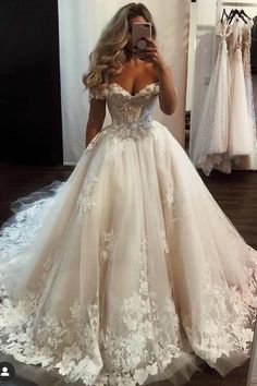 a woman is taking a selfie in her wedding dress while looking into the mirror