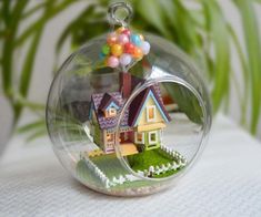 a small house in a glass ball on a table