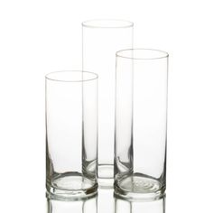 three clear glass vases sitting next to each other