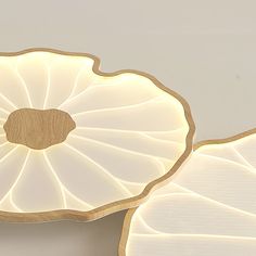 two white flower shaped lights on a table