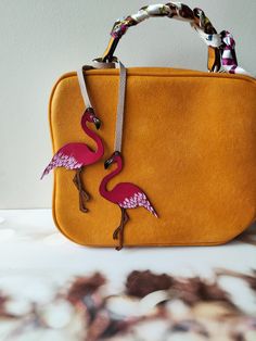 "This is 100 % handmade work. Make a bag unique! This Flamingo bag charm is handmade from premium leather and hand painted. The leather purse charm is just beautiful. This unique handmade leather charm would make a lovely gift for any Birds lover. The leather bag charm could also be given as a little gift for a friend or sister! Completely handcrafted as the hand cut leather is hand-painted and hand-burnished. Width of Flamingo approximately 2.5 inches (6.5 cm). Height of Flamingo approximately Miniature Objects, Flamingo Bag, Make A Bag, Handbags Handmade, Custom Handbags, Unique Roses, Bag Charms, Veg Tan Leather, Handbag Charms