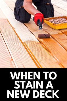 a man in black shirt and red gloves working on wooden floor with text overlay that reads, when to stain a new deck