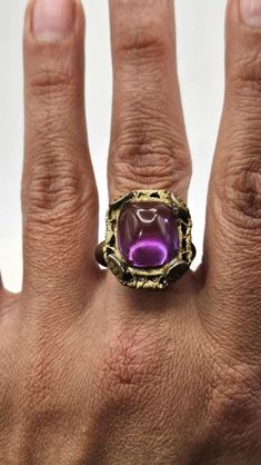 Vintage c. 1970s purple-pink hand crafted poured glass ring. Expedited shipping is available by request on a case by case basis. Please message us if you require rush shipping. Returns are are accepted within the time window noted. To recieve a full refund the return must meet one of the following criteria. All other returns are subject to restocking fees. 1. Item was late or not delivered 2. Item arrived dammaged 3. Item did not match description/pictures Vintage Metal Rings For Party, Handmade Vintage Pink Rings, Vintage Crystal Ring With Cabochon, Vintage Pink Cabochon Ring, Vintage Purple Crystal Round Ring, Vintage Purple Round Crystal Ring, Vintage Purple Crystal Ring, Purple Gemstone Party Rings, Purple Gemstone Rings For Party