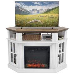 a flat screen tv sitting on top of a white fireplace