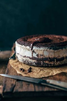 a chocolate cake sitting on top of a wooden cutting board