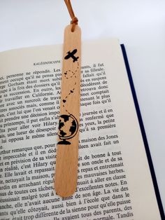 a wooden bookmark with an image of the earth on it