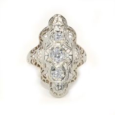 Antique Eduardian circa 1910 Diamond Ring in 14 karat white gold on Etsy, $2,575.00 Antique Platinum Three-stone Jewelry, Ornate 14k Gold Filigree Ring With Intricate Design, Ornate Oval White Gold Filigree Ring, Vintage Diamond White Diamond Ring With Filigree, Art Deco Silver Diamond Ring In 14k Gold, Silver 14k Gold Art Deco Diamond Ring, Antique Filigree Ring In Diamond White For Formal Occasions, Ornate White Filigree Ring With Intricate Design, Antique Filigree Engraved Promise Ring