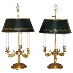 two lamps with black shades and gold trim