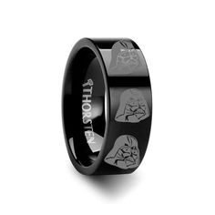 a black ring with star wars symbols on the inside and an image of darth vader